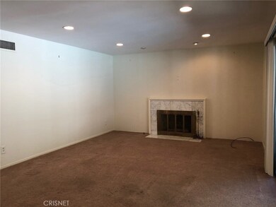 Large living room warmed by fireplace, smooth ceilings and recessed lights