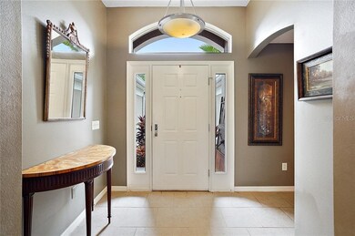 Front entrance with tile flooring and high ceiling
