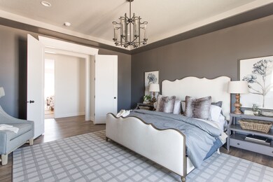 Bedroom with a chandelier and wood finished floors