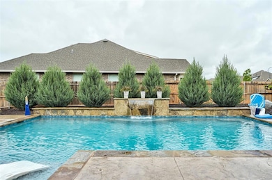 View of swimming pool with a fenced backyard