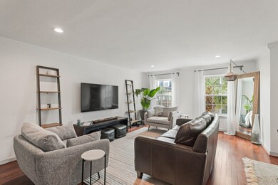 Stunning living room with wood floors, recessed li