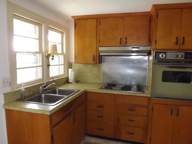 Kitchen with built in oven and cooktop.