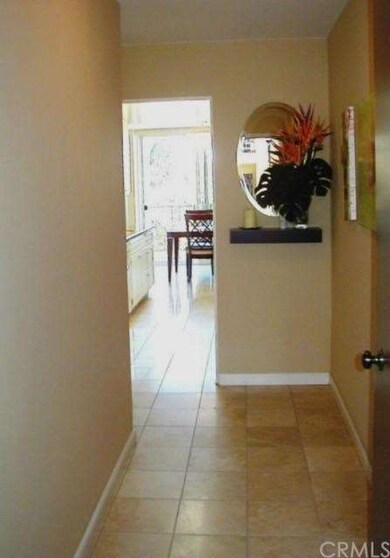 The hallway entry is travertine tile, with entry t