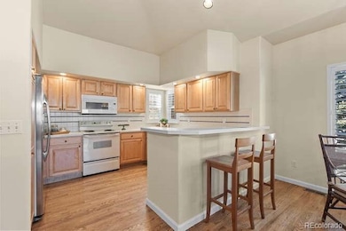 Spacious kitchen with breakfast bar seating, ample cabinetry and open sightlines