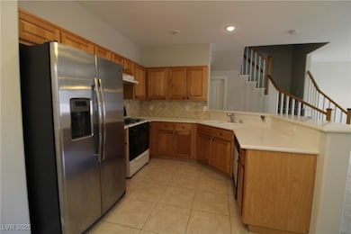Kitchen featuring stainless steel refrigerator wit