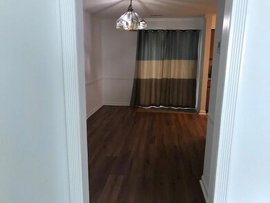 Unfurnished room featuring hardwood / wood-style floors and a chandelier