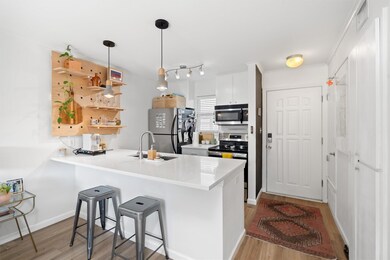 Kitchen with a peninsula, a sink, a kitchen break