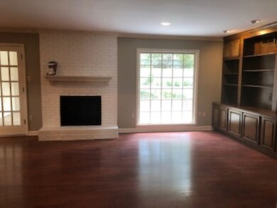 Spacious family room with book shelves and french 