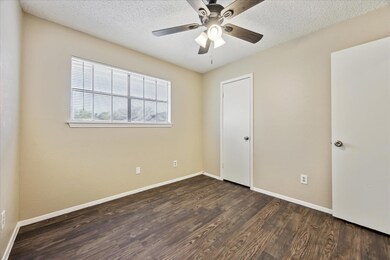 Unfurnished bedroom with dark wood finished floor
