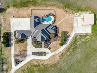 Nestled on a sprawling 34-acre lot, the home is adorned with a distinctive 1/4-mile concrete drive, ensuring a grand entrance.