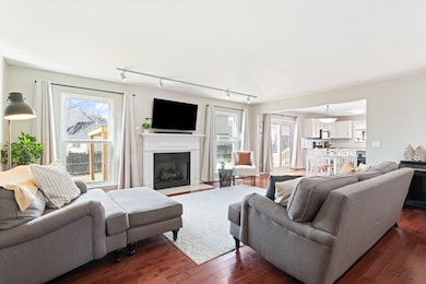 Living room with gas fireplace opens to eat-in kitchen