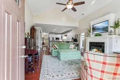 Living room featuring ceiling fan, high vaulted ce