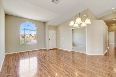 Living and dining room areas with an adjacent den