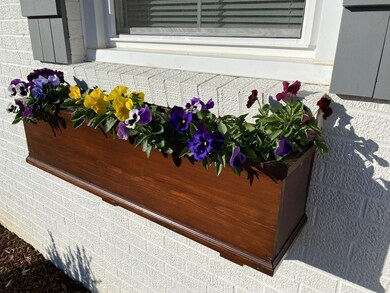Wood window flower boxes on all the front windows to plant your favorite flowers in.