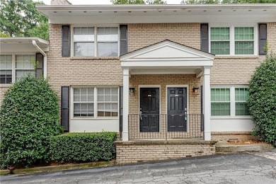 Doorway to property featuring brick siding