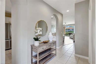 Foyer corridor featuring neutral tile floors