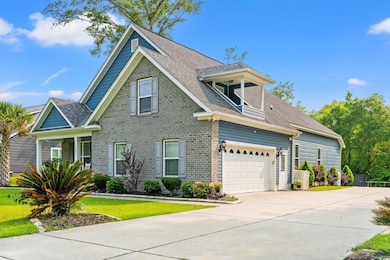 View of front facade featuring driveway, a garage, a front lawn, and a shingled roof