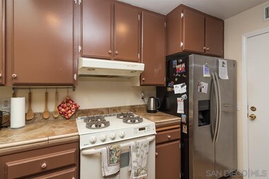 Kitchen features tile flooring and tile counter to
