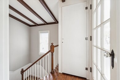 Second floor stairway/landing features a private storage closet and door to balcony.