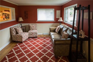 LIVING ROOM WITH NEW WINDOWS, AND HARD WOOD FLOORS