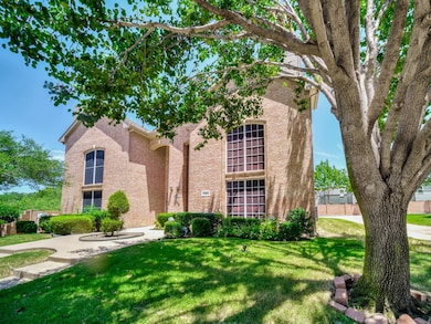 View of front facade with a front lawn and brick siding