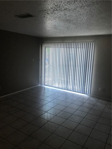 Tiled spare room with a textured ceiling
