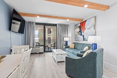 Living room featuring a beam ceiling with lights, 