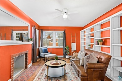 Living room with a brick fireplace, wood finished 