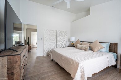 Bedroom with ceiling fan, a towering ceiling, and 