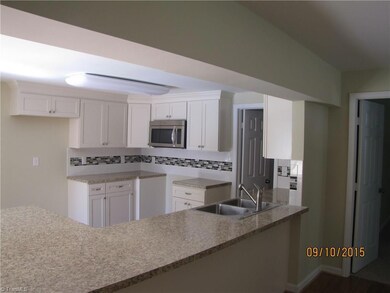 Big & Bright Kitchen w/eat -at counter bar. New all wood cabinets w/soft close drawers, tile backsplash, Stainless Steel built-in microwave & dishwasher. Door in Kitchen leads to a walk-in Pantry.