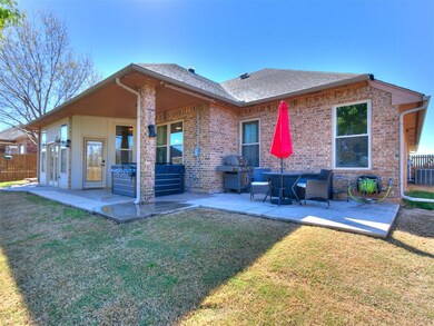 Back of house with a yard, a patio area, and centr