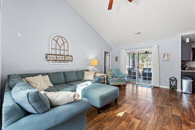 Living room featuring ceiling fan, dark wood-type 