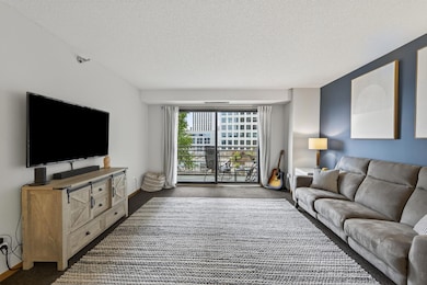 Walk out through the oversized sliding door to the balcony overlooking the beautifully landscaped pool area.