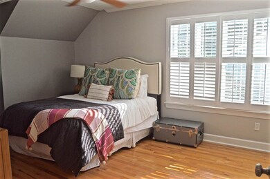 Upstairs bedroom with hardwood floors, lots of clo