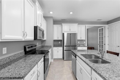 Kitchen with sink, light tile patterned floors, li
