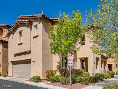 View of front facade featuring stucco siding, a ga