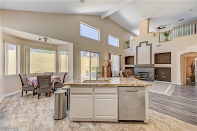 Kitchen with a sink, open floor plan, dishwasher,