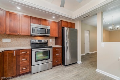 Kitchen featuring backsplash, light hardwood / woo