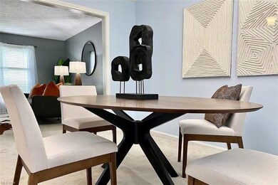 Carpeted dining room featuring a textured ceiling