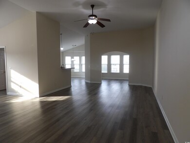 Unfurnished living room with dark wood finished fl