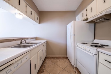 Kitchen featuring white cabinets, under cabinet ra