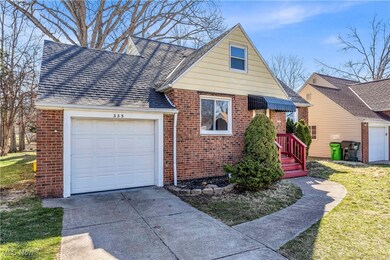 View of front of property featuring concrete driveway, roof with shingles, brick siding, and an attached garage