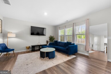 Main floor has a bright, open floorplan with a spacious living room, dining area and French doors to the outdoor garden and patio, overlooking a wooded area.