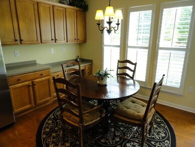 Sun filled Kitchen Nook with hardwood floors.  