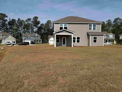 Back of house featuring a yard