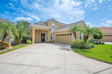 The wide sweeping driveway is surrounded by lush mature tropical landscaping.