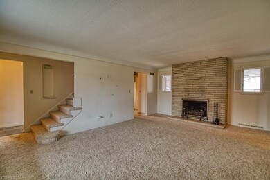 The living room has a floor-to-ceiling stone firep