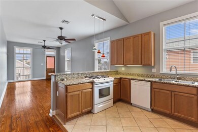 Kitchen open to the living room with tall vaulted