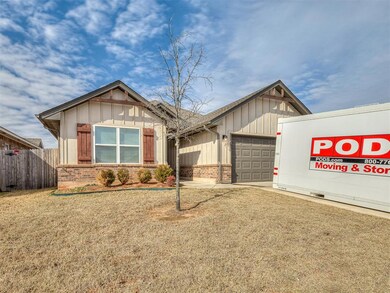 View of front of home with a garage and a front ya