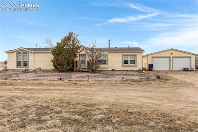 View of front of home with an outdoor structure